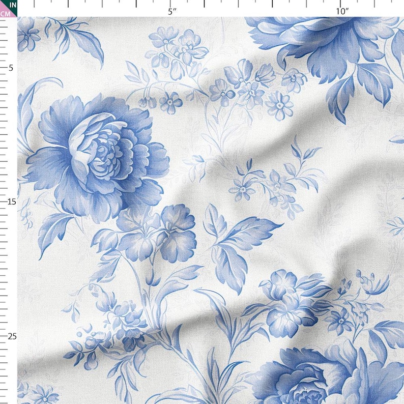 a close-up view of a fabric with a blue floral pattern. The pattern consists of various blue flowers and leaves, creating a visually appealing and intricate design. The fabric appears to be made of a soft, textured material, which adds to the overall aesthetic of the image.