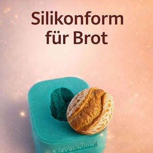 Könnte beinhalten: Eine türkisfarbene Silikon-Brotform mit einem Brotlaib daneben. Das Brot ist goldbraun mit einer strukturierten Oberfläche. Der Text "Silikonform für Brot" steht oben.
