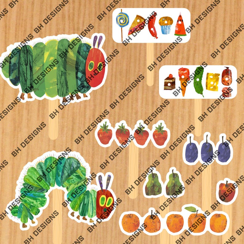 May include: A selection of illustrated food and caterpillar-themed cutouts on wooden sticks. The cutouts feature strawberries, plums, pears, oranges, and slices of cake, alongside a lollipop and a cupcake. The caterpillar has a red head and green body.