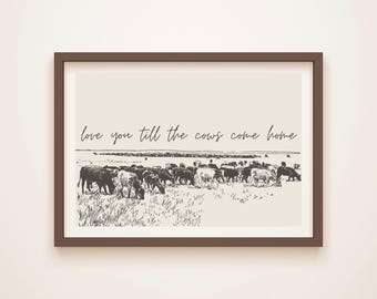 May include: Framed art print featuring a sepia-toned illustration of cows grazing in a field. The artwork includes the handwritten text, "love you till the cows come home." The print is set in a brown frame.