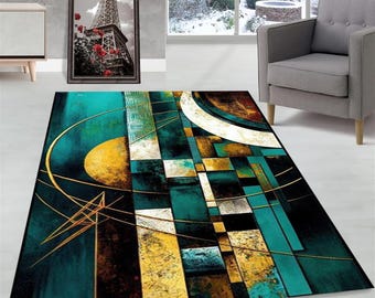 May include: Abstract area rug with geometric shapes in shades of teal, gold, brown, and white. The rug has a modern design with a distressed look.