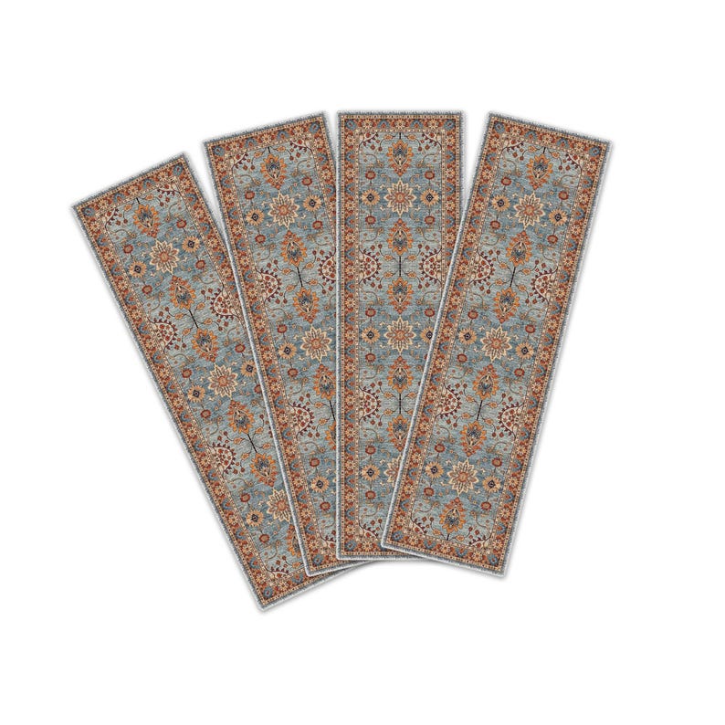 May include: Four rectangular rugs with a traditional floral pattern. The rugs have a light blue background with orange, brown, and cream-colored floral designs. The edges are bordered with a cream-colored trim.