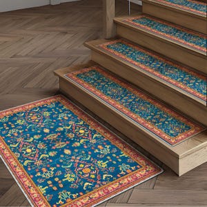 May include: A set of stair treads and a matching rug with a traditional Persian design. The rugs and treads feature a teal background with a detailed pattern in yellow, orange, and red. The edges are bordered with a red and yellow trim.
