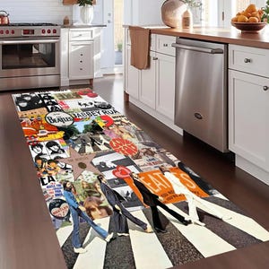 May include: A black and white runner rug featuring a collage of Beatles album covers and photos. The rug includes the iconic Abbey Road album cover with the Beatles walking across a zebra crossing.