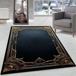 May include: A rectangular area rug with a dark blue center and a black border. The border features ornate gold-colored filigree designs. The rug is placed on a white floor, with a gray armchair and a framed picture of the Eiffel Tower in the background.
