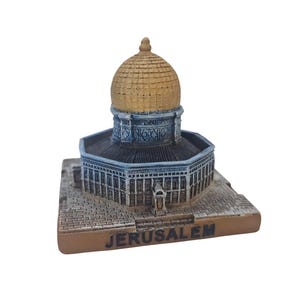 May include: A miniature replica of the Dome of the Rock in Jerusalem, a gold-domed building with intricate details and a stone base.