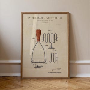 Puede incluir: Impresión enmarcada de patente vintage de un pasapurés. La impresión presenta una ilustración detallada de la herramienta de cocina con un mango de madera y componentes metálicos. El texto "United States Patent Office" está en la parte superior.