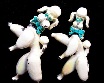 50s Poodle pins. 2 White enamel brooches with dogs. Green eyes.