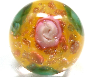 Paperweight glass button, Vintage glass with pink flower, yellow background.