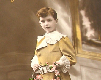 1900s French Postcard. Edwardian boy with flowers. RPPC real photo, paper ephemera. Carte Postale. Vintage collectible.