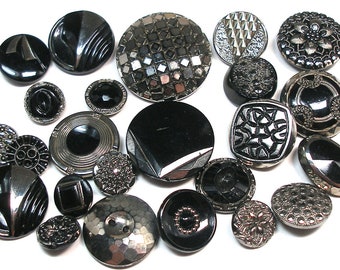 24 Art Deco black glass buttons. Early 20th century glass with silver luster.