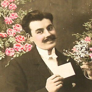 1900s French postcard with man holding flowers. RPPC real photo postcard, paper ephemera. Carte Postale. Vintage collectible. fashion
