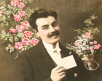 1900s French postcard with man holding flowers. RPPC real photo postcard, paper ephemera. Carte Postale. Vintage collectible. fashion