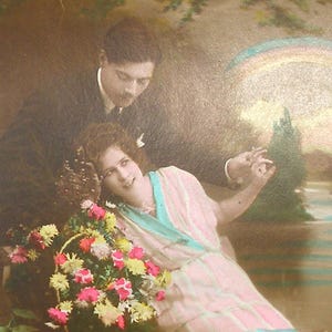 1920s French postcard with romantic couple & rainbow. RPPC Real photo, paper ephemera. Carte Postale. Vintage collectible.