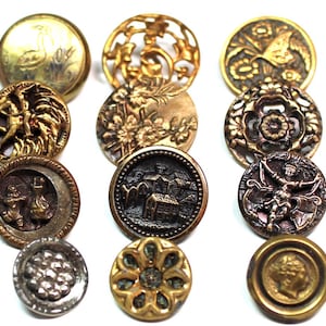 Puede incluir: Una colección de botones antiguos de metal de varias formas y tamaños. Los botones presentan diseños intrincados, incluyendo patrones florales, un cisne y una figura clásica. Los colores incluyen oro, bronce y plata.
