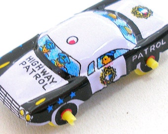 Mini 1960s tin toy police car, vehicle in black & white. Made in Japan.