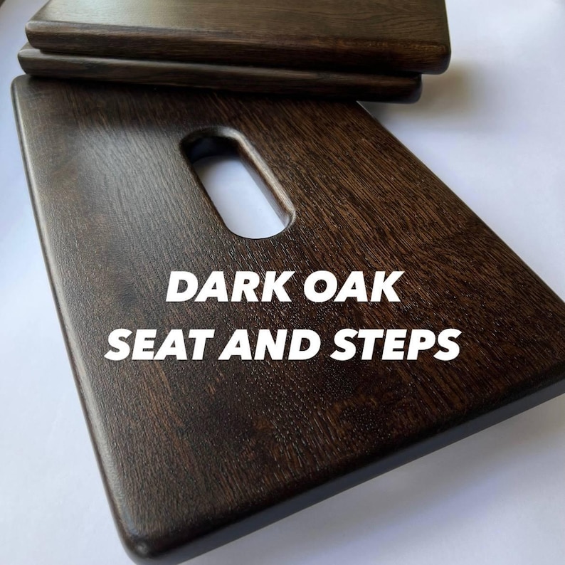 May include: Dark oak seat and steps. The image shows a set of dark brown wooden steps and a seat. The seat has a rectangular shape with a handle-like cutout. The text "DARK OAK SEAT AND STEPS" is displayed in white.