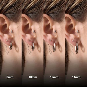 May include: A set of four silver-toned hoop earrings shown in ear piercings, demonstrating size variations of 8mm, 10mm, 12mm, and 14mm. Each hoop is a simple, smooth, circular metal ring, accompanied by a small moon-shaped stud and a ball stud.