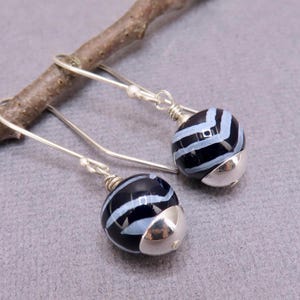 Handmade African free trade bead dangle earrings with sterling silver accents, handmade clay beads in black and lavender,  drop earrings