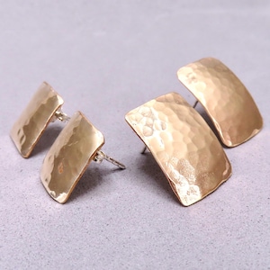 May include: Three gold-toned hammered square earrings. The earrings are all the same size and shape, but have different textures.