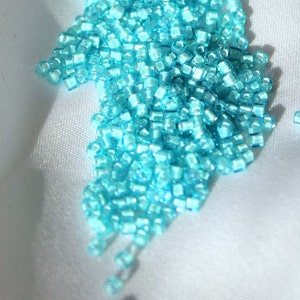 1.5mm Toho cube, White Lined Aqua, 10-gram bag, color # T1.5 cube 930