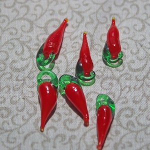 6 Small Glass Chili peppers they are 1 in in size.