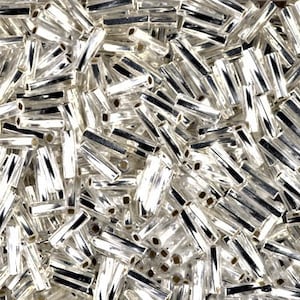 May include: A large pile of silver glass beads in a tube shape. The beads are shiny and reflective.