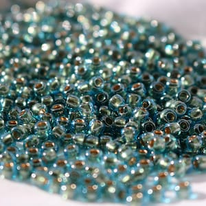 6/0 Gold-Lined Aqua Toho seed bead, 20 grams, Color# TR-06-990. Great for Macrame, beading, Knitting