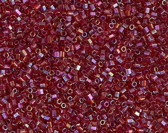 May include: A close-up image of a large quantity of small, red, iridescent glass beads. The beads are cube-shaped and have a shiny, reflective surface.