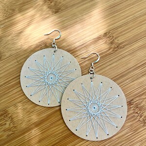 Scandinavian Star Sacred Geometry Earrings Hand Embroidered Light Gray on Beige Paper