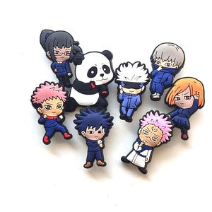 May include: A collection of eight small, colourful, rubberised shoe charms featuring chibi-style anime characters. The set includes figures with pink, black, orange, and white hair, a panda character, and various blue and white outfits in dynamic poses.