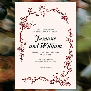 May include: Wedding invitation with a cream background and a floral border in a dark red hue. The text reads "Jasmine and William" with the date and time of the ceremony. The location is The Garden Pavilion, Amsterdam, The Netherlands.
