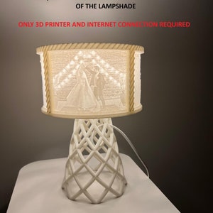 May include: A white 3D printed lamp with a geometric design base and a white lampshade with a picture of a wedding couple inside. The text on the image reads "DIGITAL FILES AND USER GUIDE FOR PRODUCING STL FILES OF YOUR OWN PICTURES READY STL, SW AND BLENDER DESIGN FILES OF OTHER PARTS OF THE LAMPSHADE ONLY 3D PRINTER AND INTERNET CONNECTION REQUIRED".