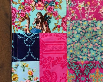 May include: A patchwork quilt with a variety of floral and mermaid patterns in shades of pink, blue, and green. The quilt is made of different fabrics and has a hand-stitched look.