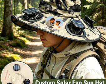 May include: A beige and black camouflage bucket hat featuring two integrated solar-powered fans on the brim. A heart-shaped patch on the front displays a photograph of two people with the text "Partners For Life" printed below the image.