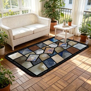 May include: A rectangular area rug featuring a geometric grid pattern of squares and rectangles in shades of blue, brown, beige, and gray. The design includes three central diamond-shaped accents with intricate, swirling patterns in blue and gold.