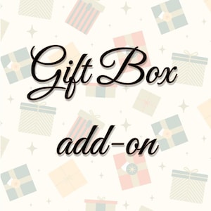 May include: Image features the words "Gift Box add-on" in a black, cursive font. The background is a light beige color with a pattern of small gift boxes in various pastel colors and white star shapes.