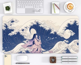 May include: A desk mat with a Japanese-style design, depicting a woman in a kimono in front of large blue waves. The mat measures 40.6 x 81.3 cm and has a cream background. The woman wears a pink kimono and has long black hair.