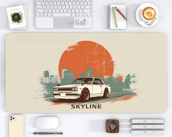 May include: A beige desk mat featuring a white vintage car driving on a road, with a large orange sun in the background and a cityscape. The word "SKYLINE" is printed below the car. The desk mat measures 16 x 32 inches.