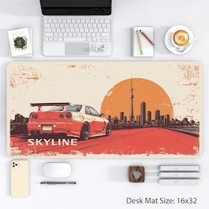 May include: Desk mat featuring a red sports car with the word "SKYLINE" in white, set against a cityscape and a large orange sun. The mat measures 16x32 inches.