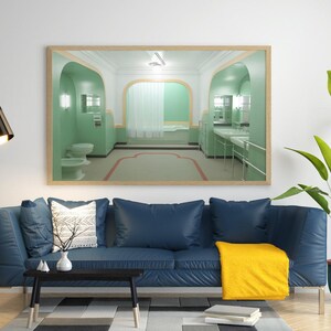 May include: A living room interior with a blue sofa, a coffee table, a floor lamp, and a framed picture of a green bathroom with a bathtub and sinks. A potted plant with green leaves is in the corner of the room.