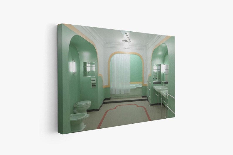 May include: A green bathroom with a white bathtub, a toilet, and a double sink. The bathroom has arched doorways and green tile floors.