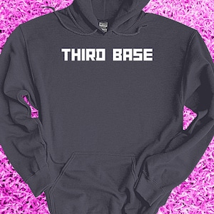 May include: A dark gray hooded sweatshirt with the text "THIRD BASE" printed in white on the front.