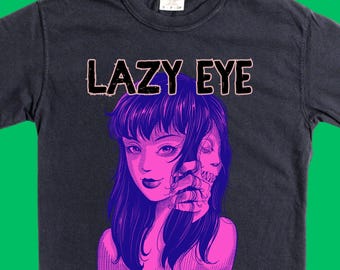 Band merch mockery. Concert tee from spoof band 'Lazy Eye.' Garment dyed concert tee with soft, vintage fade.