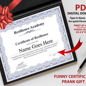 May include: A certificate of resilience in a black frame with a red bow. The certificate has a blue border and text that reads "Name Goes Here". A black pen with gold accents is on the right. The text "PDF DIGITAL DOWNLOAD" is in the upper right.