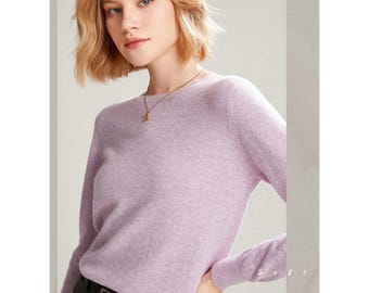 May include: A light purple long-sleeved sweater with a round neckline. The sweater is made of a soft, comfortable material.