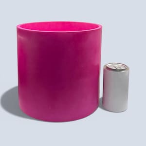 Large 23 cm handmade cylindrical plant pot in deep magenta pink, shown next to a white 330 ml drinks can for size comparison, smooth stone like finish, modern indoor planter for houseplants and statement decor.