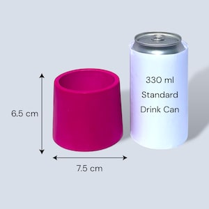 Small fuchsia tapered round plant pot with measurement arrows showing 6.5 cm height and 7.5 cm width, placed beside a standard 330 ml drinks can for size comparison on a pale grey background.