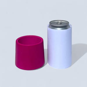 A 7.5 cm cylindrical succulent pot next to a 330ml can . The vibrant magenta pot tapers towards the top. The pot is roughly half the height of the can and slightly wider.