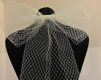 Bridal veil bow from mesh soft tulle attached to a hairpin.